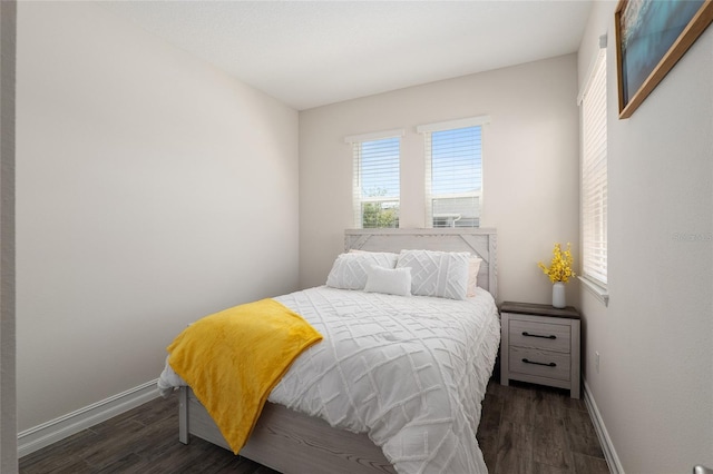 bedroom with dark hardwood / wood-style flooring