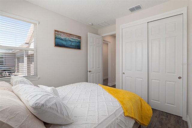 bedroom featuring a closet and dark hardwood / wood-style floors