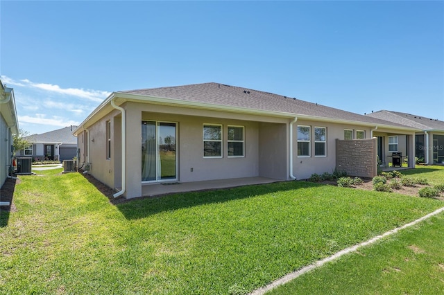 back of house featuring a patio, a lawn, and cooling unit