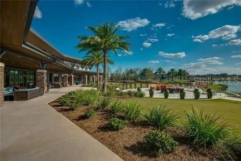 view of property's community featuring a water view and a patio area