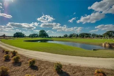 surrounding community featuring a water view and a yard