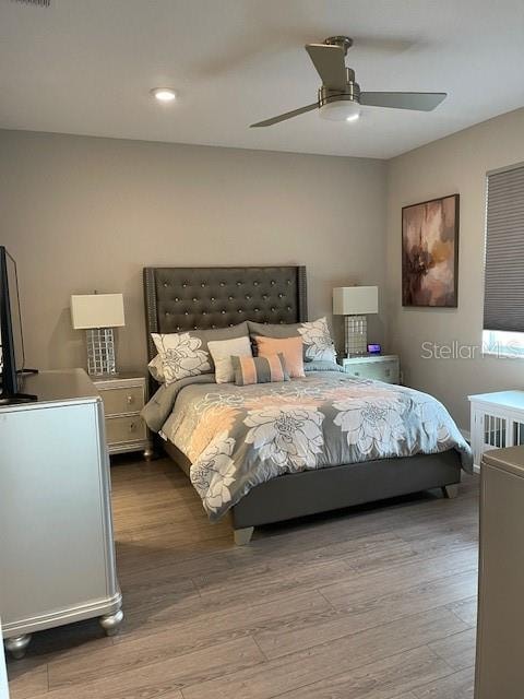 bedroom with light wood-type flooring and ceiling fan