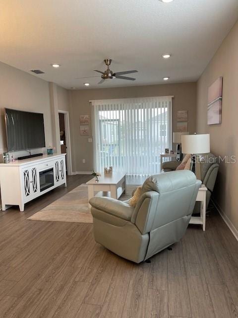 living room with hardwood / wood-style floors and ceiling fan