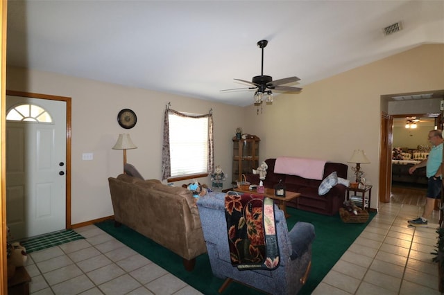 tiled living room featuring ceiling fan and lofted ceiling