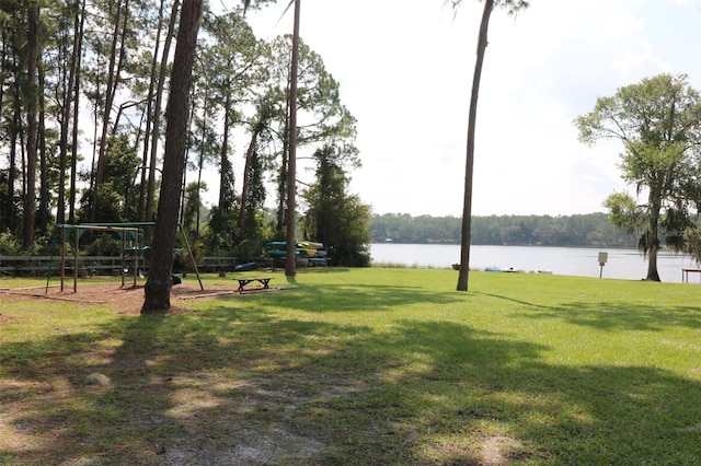 view of home's community with a lawn and a water view