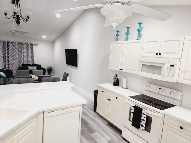 kitchen with white cabinets, light hardwood / wood-style floors, sink, and white appliances