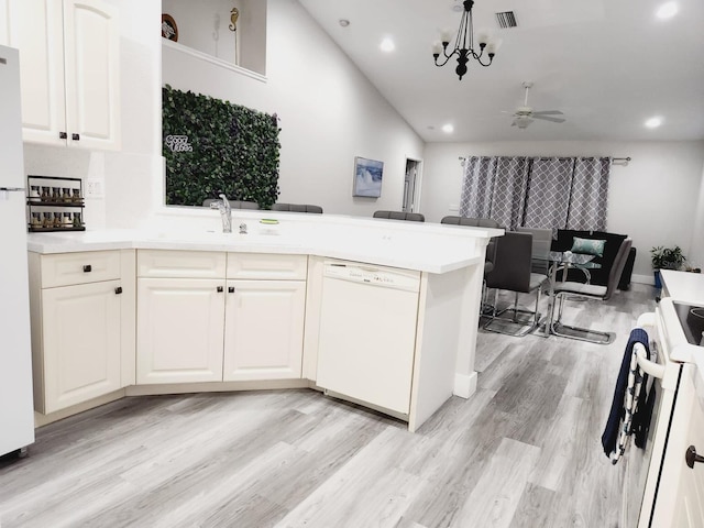 kitchen with white cabinetry, ceiling fan with notable chandelier, high vaulted ceiling, white appliances, and light hardwood / wood-style flooring