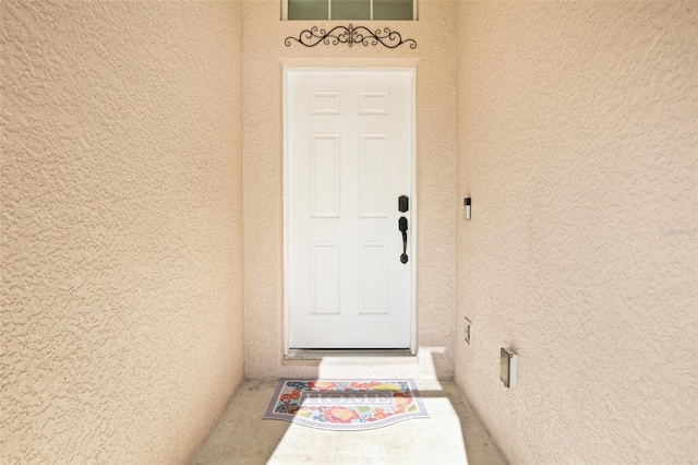 entrance to property with stucco siding