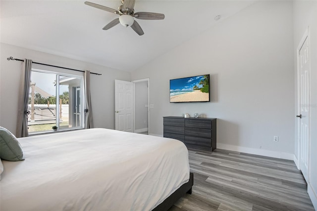 bedroom with wood finished floors, ceiling fan, baseboards, and vaulted ceiling