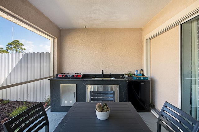 exterior space featuring a sink and beverage cooler