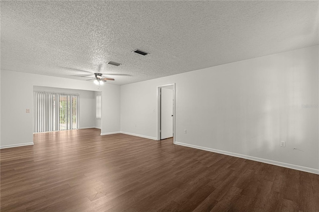 empty room with a textured ceiling, dark hardwood / wood-style floors, and ceiling fan