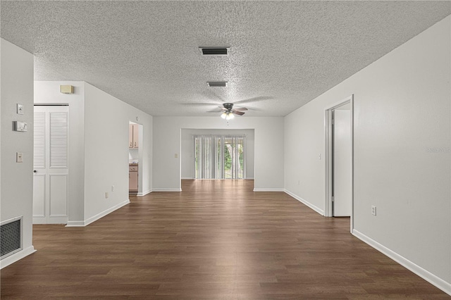 empty room with a textured ceiling, dark hardwood / wood-style floors, and ceiling fan