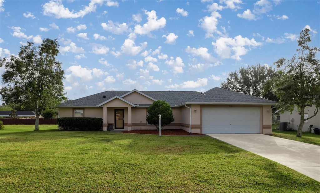 ranch-style house featuring a garage and a front lawn