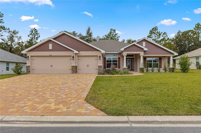 craftsman-style house featuring a garage and a front lawn