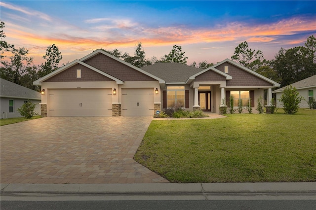 craftsman-style home with a lawn and a garage