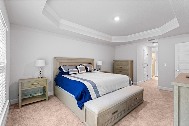 bedroom featuring a tray ceiling, light colored carpet, and crown molding