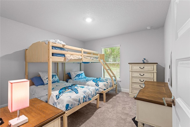 carpeted bedroom featuring a textured ceiling