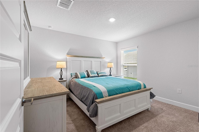 bedroom with a textured ceiling and carpet flooring