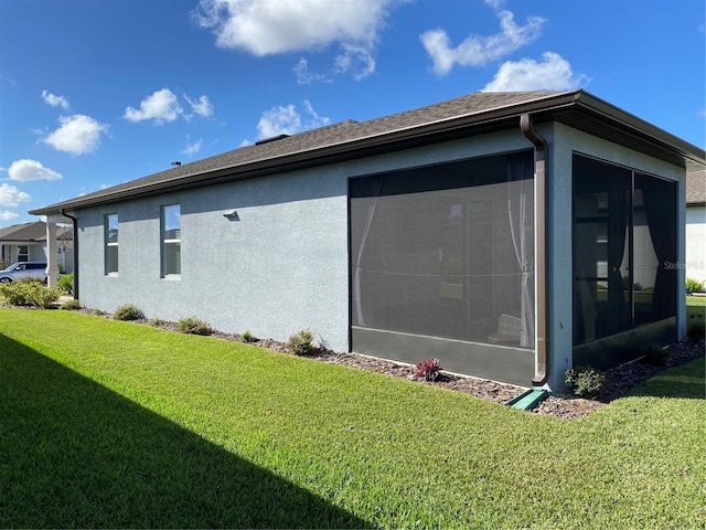 view of property exterior with a lawn and a sunroom