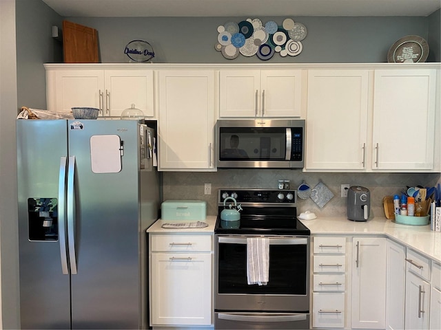 kitchen featuring tasteful backsplash, white cabinets, and stainless steel appliances