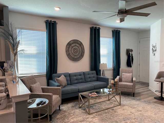 living room featuring plenty of natural light, light hardwood / wood-style floors, and ceiling fan