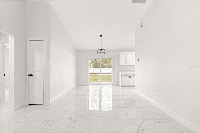 unfurnished living room with high vaulted ceiling