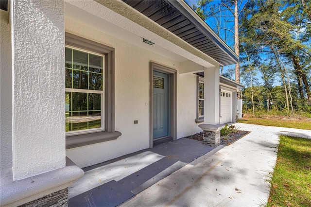 doorway to property with a garage