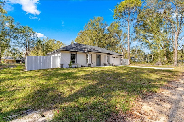 single story home featuring a garage and a front lawn