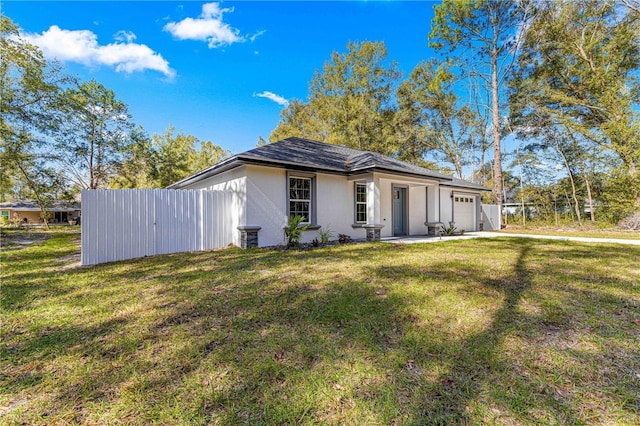 view of front of home with a front lawn and a garage