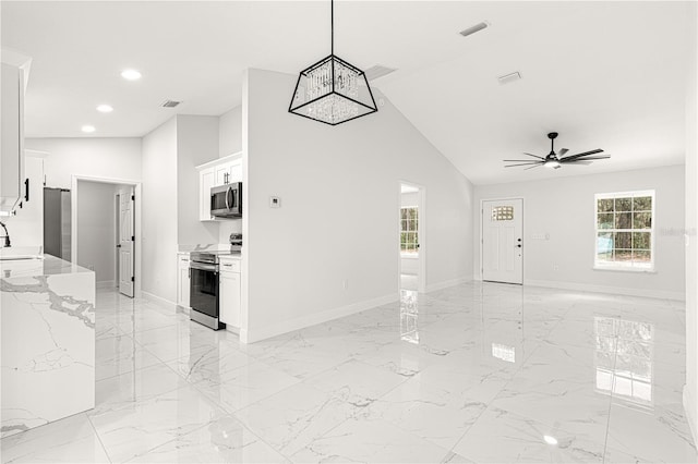 interior space featuring ceiling fan, sink, and lofted ceiling