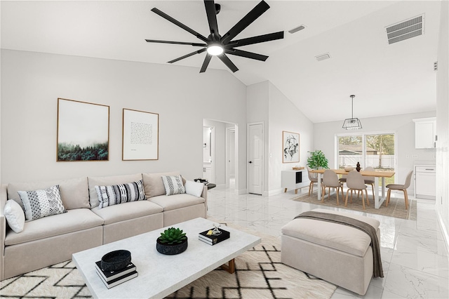 living room featuring ceiling fan and lofted ceiling