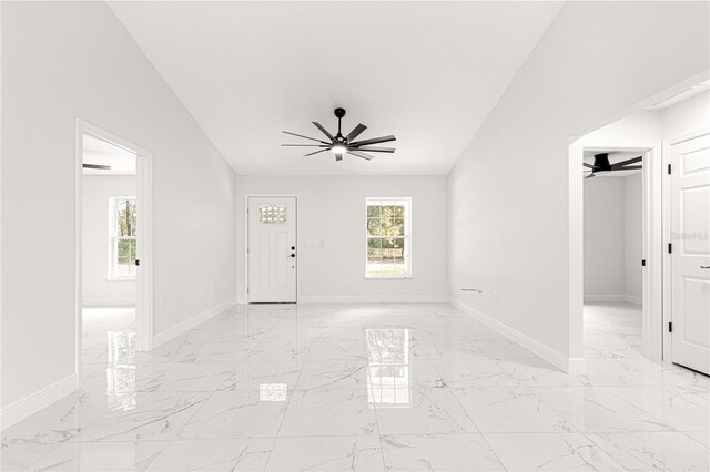 interior space with ceiling fan