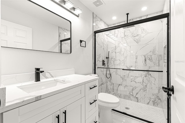 bathroom featuring vanity, toilet, and walk in shower