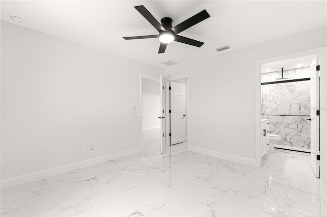 unfurnished bedroom featuring ceiling fan and connected bathroom