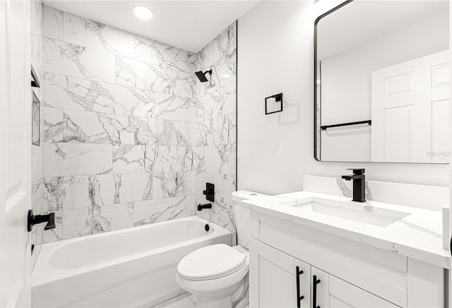 full bathroom featuring toilet, tiled shower / bath, and vanity