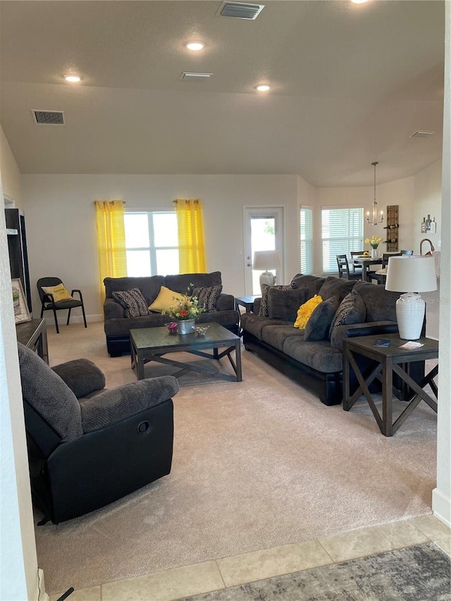 living room with a chandelier, light carpet, and a healthy amount of sunlight