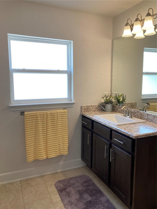 bathroom featuring a wealth of natural light, vanity, and tile patterned floors