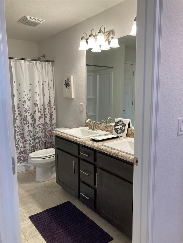 bathroom featuring a textured ceiling, curtained shower, vanity, tile patterned floors, and toilet