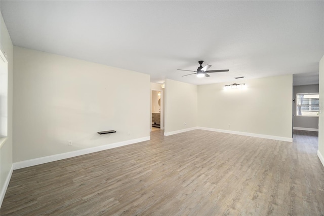 empty room featuring ceiling fan and hardwood / wood-style floors