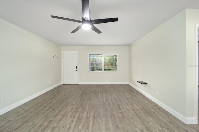 unfurnished room with ceiling fan and hardwood / wood-style floors