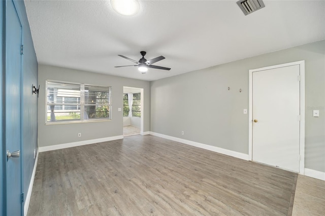 spare room featuring ceiling fan, a textured ceiling, and hardwood / wood-style floors