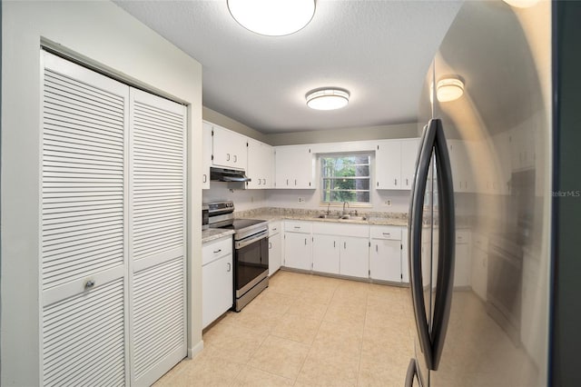 kitchen with white cabinets, appliances with stainless steel finishes, sink, and a textured ceiling