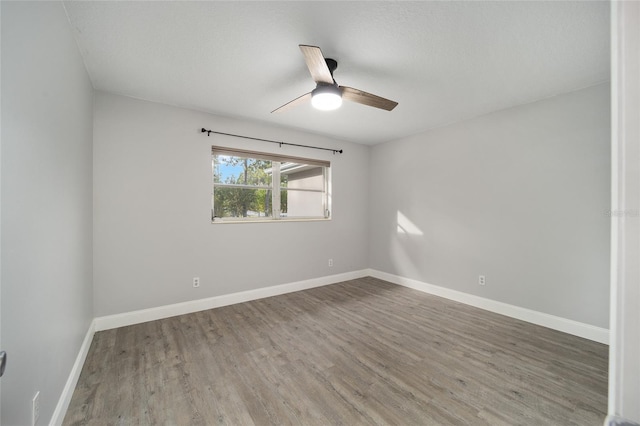 unfurnished room with ceiling fan and hardwood / wood-style floors