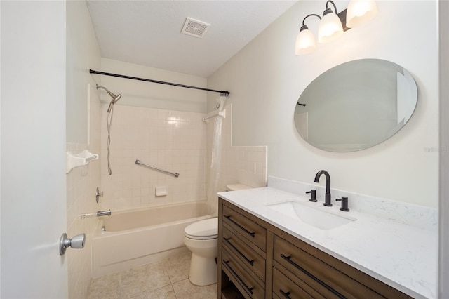 full bathroom featuring toilet, tiled shower / bath, tile patterned floors, and vanity