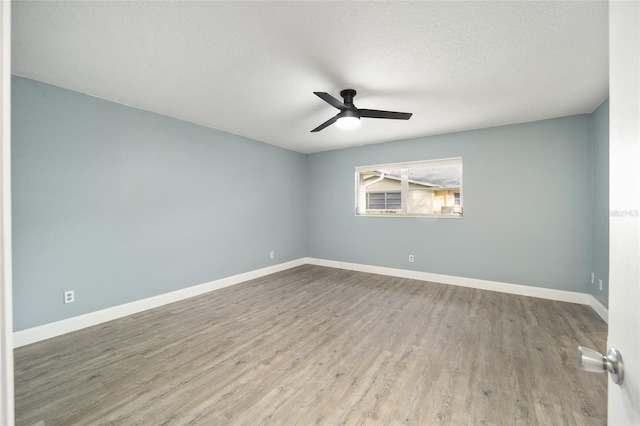 unfurnished room with ceiling fan, a textured ceiling, and hardwood / wood-style flooring