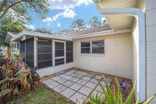 back of property featuring a patio area and a sunroom