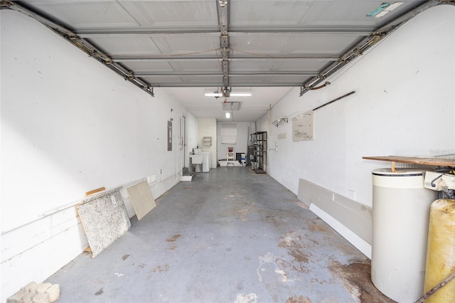 garage featuring sink, electric panel, and a garage door opener