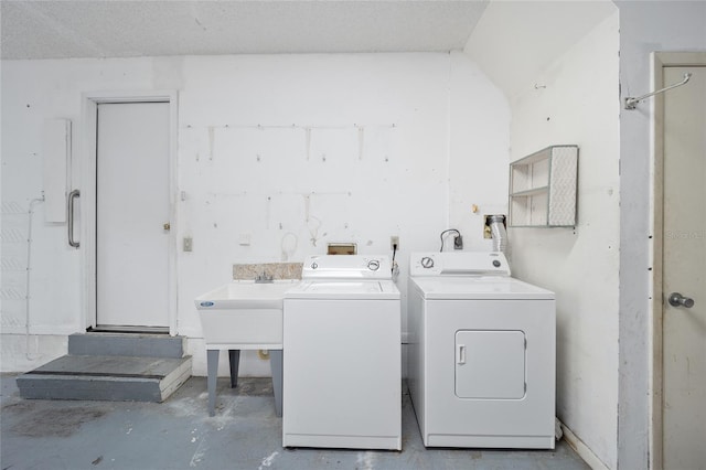 laundry room featuring washing machine and dryer and sink