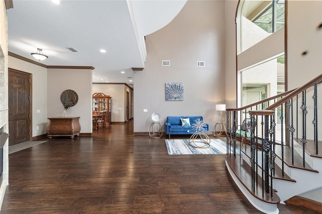 foyer entrance featuring dark wood-type flooring and ornamental molding