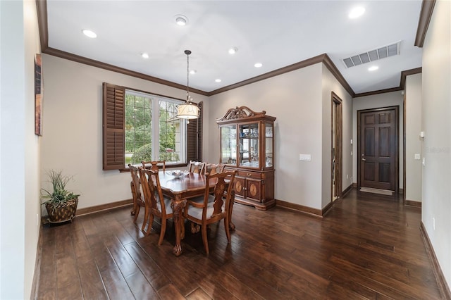 dining area with dark hardwood / wood-style floors and ornamental molding